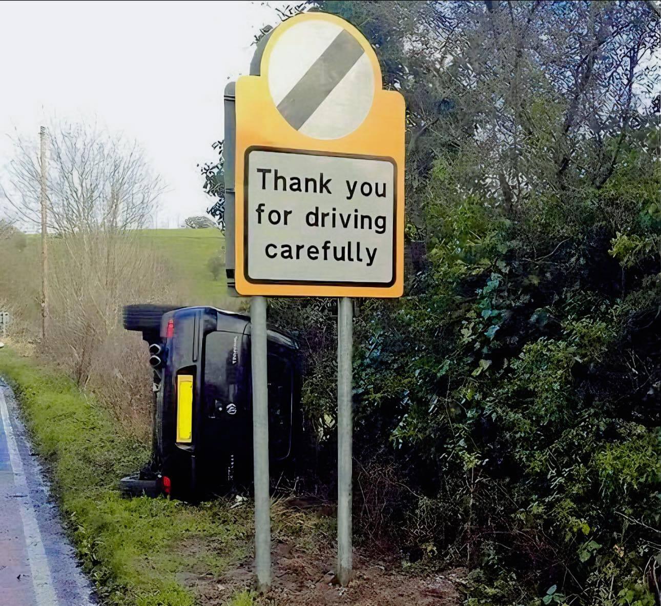 7-14-2024 thank you for driving carefully sign with a car tipped over on its side from an accident dank memes