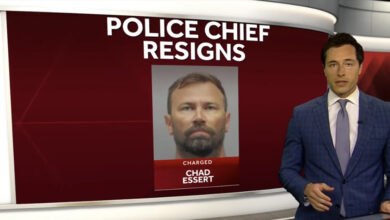 News anchor in a blue suit reports on Bethel, Ohio Police Chief Chad Essert's resignation following a 70-count sexual misconduct indictment, with Essert's mugshot displayed on a red screen with "POLICE CHIEF RESIGNS" text.