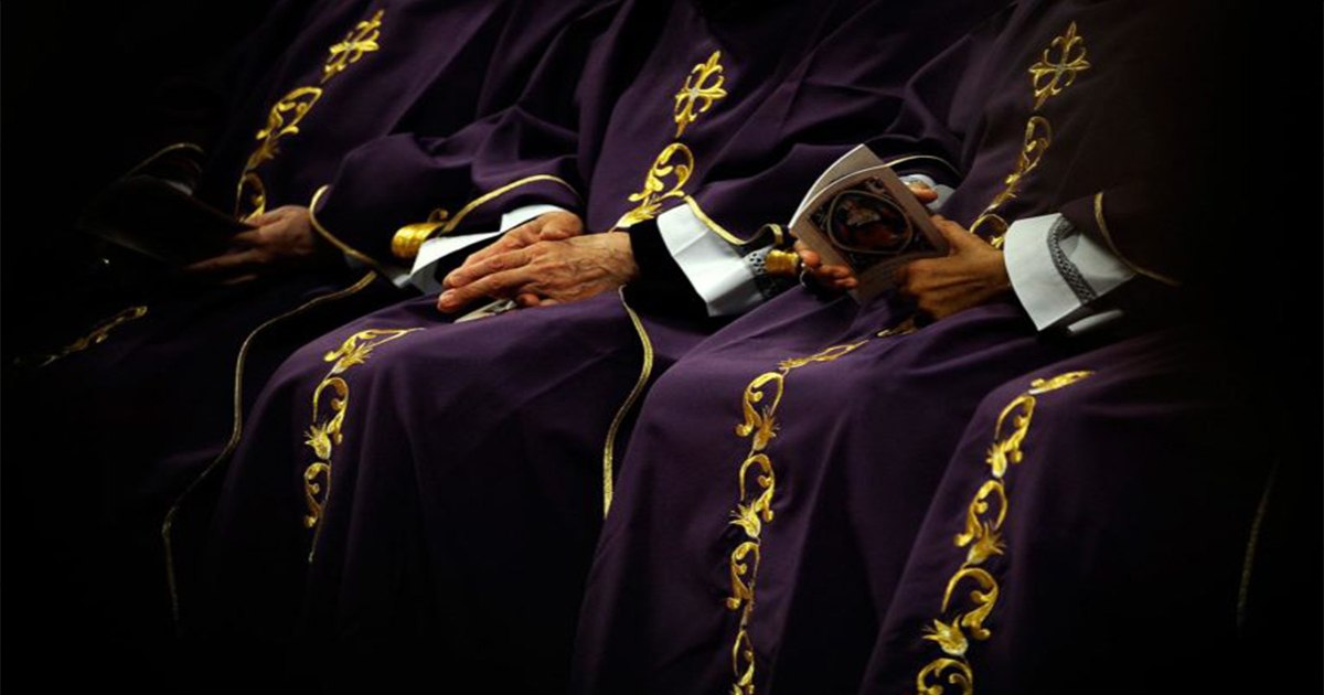 Clergy in purple robes with gold embellishments.