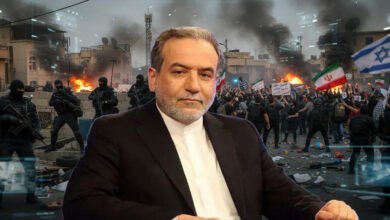 Iranian Foreign Minister in the foreground, with a backdrop of chaotic unrest: fires, protesters, and armed security forces. An Israeli flag is visible amidst the turmoil, hinting at accusations of Mossad involvement.