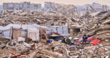 Gaza rubble shows the aftermath of conflict as Israel demands staff and financial data from humanitarian organizations. The scene depicts devastation, with people amidst the ruins of buildings. Aid access restrictions are impacting Gaza civilians.