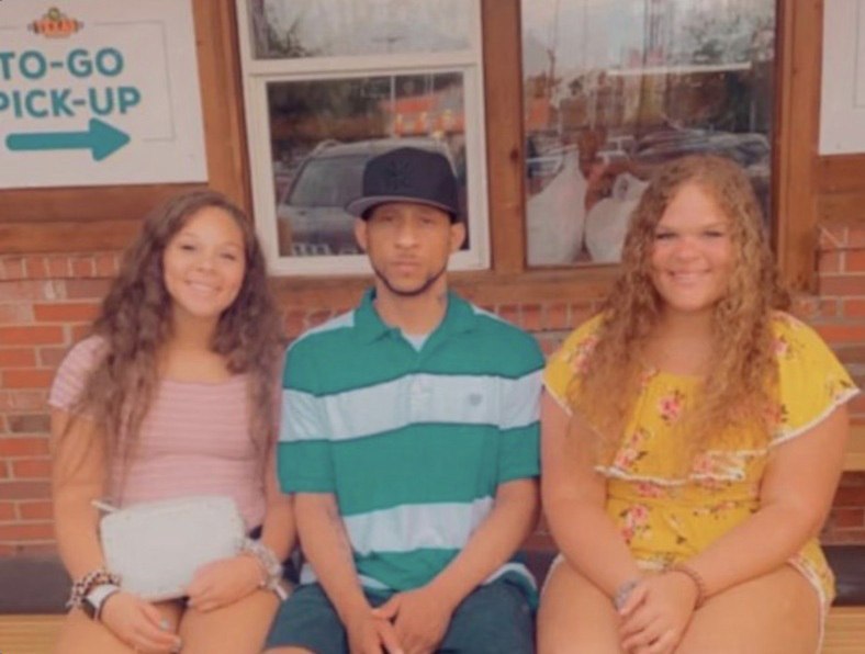Michael Broady sits with two young women. The photo is used in coverage of the Reform, Alabama, case and the Broady v. Herd federal lawsuit.