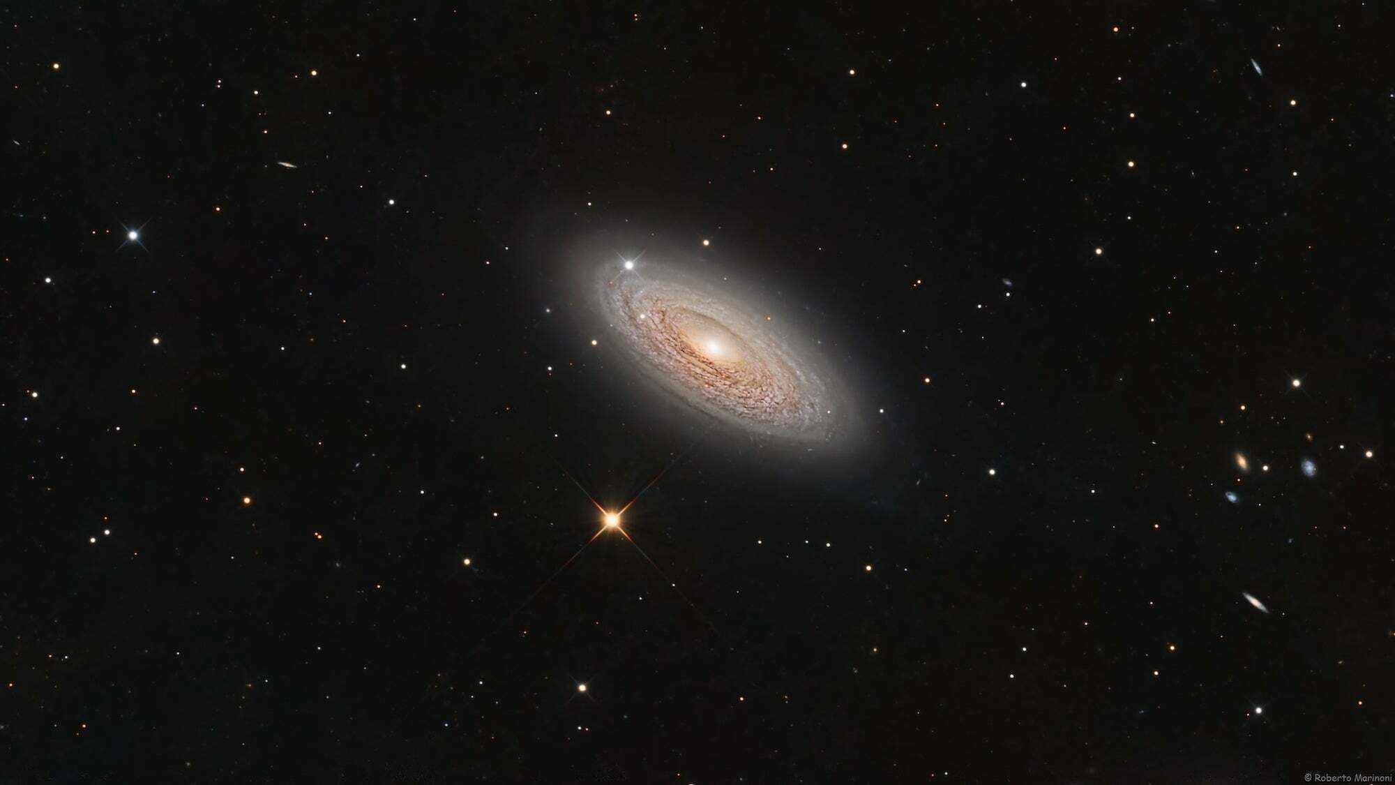Telescope image of spiral galaxy and stars