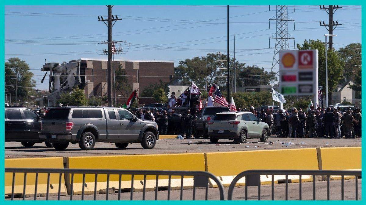 Pickup trucks and a crowd with flags face off near a gas station outside Palestine Fest, inside a teal frame