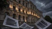 Scattered, redacted documents lie on a street in front of the illuminated, ornate facade of the UK Foreign Office building under a dramatic, cloudy sky, hinting at buried assessments on Israeli war crimes.