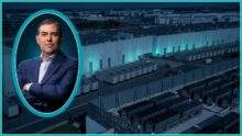 AWS chief Matt Garman inside a bright teal oval in front of a hyperscale data center full of cooling equipment