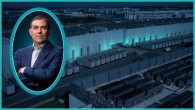 AWS chief Matt Garman inside a bright teal oval in front of a hyperscale data center full of cooling equipment
